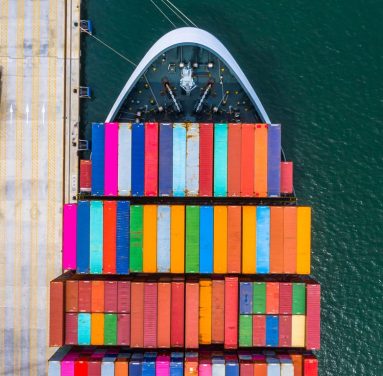 Container ship loading and unloading in deep sea port, Aerial top view of business logistic import and  export freight  transportation by container ship in open sea.